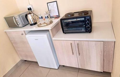 a microwave sitting on top of a counter in a kitchen at Glamour C-rane lodge in Phalaborwa