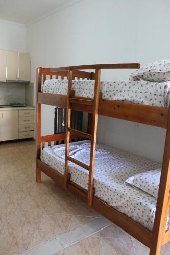 two bunk beds in a room with a kitchen at Hotel VANGJELI Orikum in Orikum