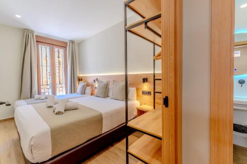 a bedroom with a large bed in a room at Hotel La Milagrosa in Alicante
