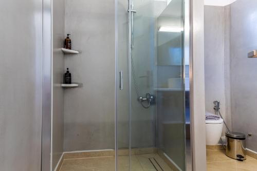 a shower with a glass door in a bathroom at Pyrgaki Hotel in Parikia