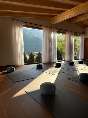 a room with yoga mats in a room with windows at Aparthotel Iris in Auffach