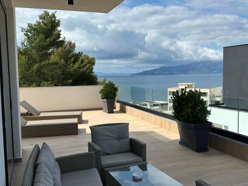 a patio with a view of the ocean on a building at Meraviglia Boutique Hotel in Sarandë