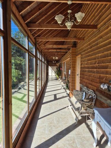 a covered porch with chairs and a ceiling fan at Thaxted Bed & Breakfast and Accommodation in Thaxted