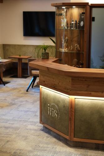 a reception desk with a fish tank in a room at Aparthotel Iris in Auffach