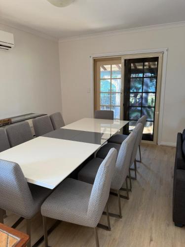 a conference room with a white table and chairs at Waters Edge Retreat in Dawesville