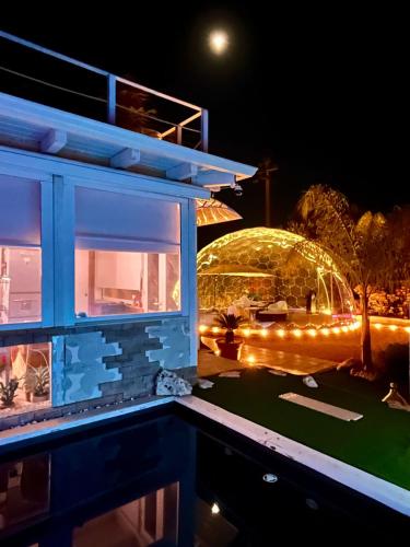 a view of a building at night with lights at Bubble World Wild Love in Adelfia