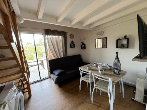 un salon avec une table et un canapé dans l'établissement Pavillon Beau Soleil à Narbonne Plage, à Narbonne-Plage