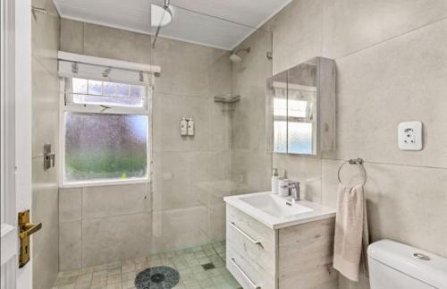 a bathroom with a sink and a shower at Knysna River Club Getaways - Luxury waterfront chalets in Knysna