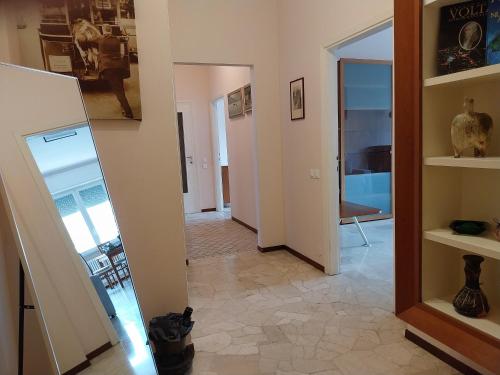 a room with a hallway with a mirror and a room with a vase at Residenza Cadorna in Como