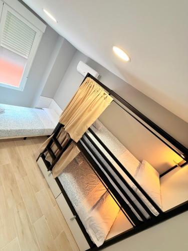 a room with a bed in the attic at Hostel VAM Torrejón in Torrejón de Ardoz
