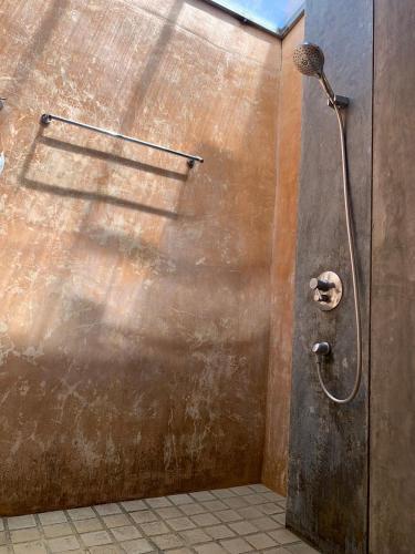 a shower in a bathroom with a metal wall at Wind Beach Resort in Koh Tao