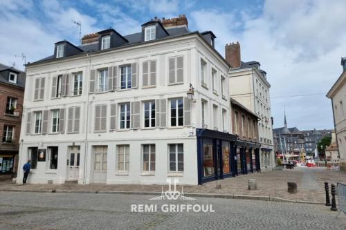 a white building on the corner of a street at Hypolite 1 Cosy Apartment 80 meters from the Port of Honfleur 2 guest in Honfleur