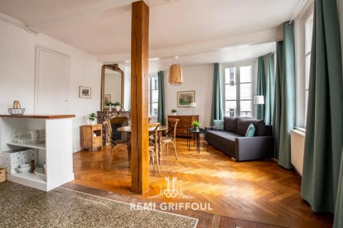 a living room with a couch and a table at Hypolite 1 Cosy Apartment 80 meters from the Port of Honfleur 2 guest in Honfleur