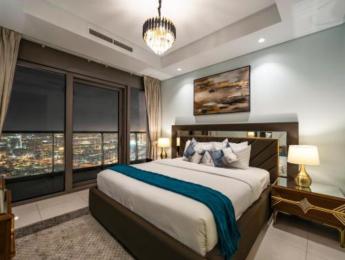 a bedroom with a large bed with a large window at Famous Infinity Pool 64th floor near Burj Khalifa in Dubai