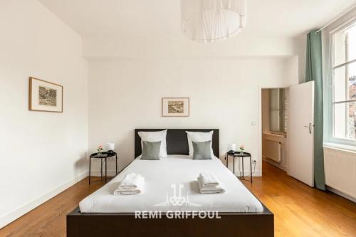 a bedroom with a large white bed in a room at Hypolite 1 Cosy Apartment 80 meters from the Port of Honfleur 2 guest in Honfleur