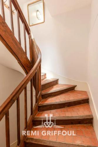 a staircase in a house with wooden steps at Hypolite 1 Cosy Apartment 80 meters from the Port of Honfleur 2 guest in Honfleur