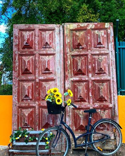 a bike parked in front of a red door at A Casa da Carrasqueira, Sesimbra in Sesimbra