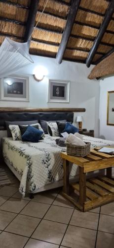 a bedroom with a bed and a wooden table at African Ambience Guest House in St Lucia