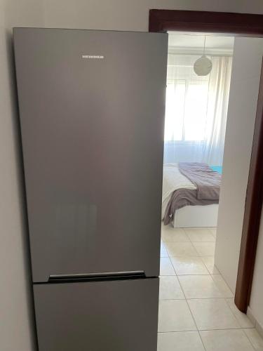 a refrigerator in a room with a bedroom at Sun&See in Durrës