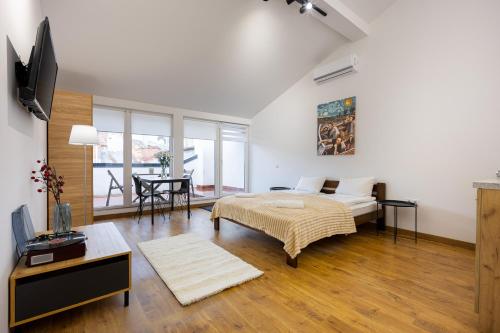 a bedroom with a bed and a living room at Апартаменти на Площі ринок 3 in Lviv