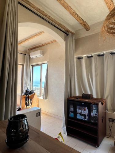 a living room with a television in a room at SurfAppart Morocco in Tamraght Ouzdar