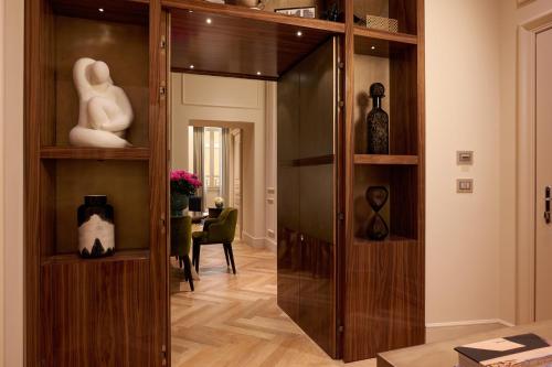 a large wooden cabinet in a room with a table at The First Arte - Preferred Hotels & Resorts in Rome