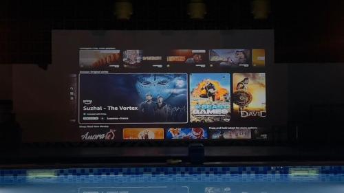 a television screen with many movies on it at Kuku Farm Stay in Venkatāpur