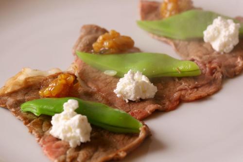 a piece of food with cheese and green peppers on it at KAMENOI HOTEL Kujukuri in Asahi