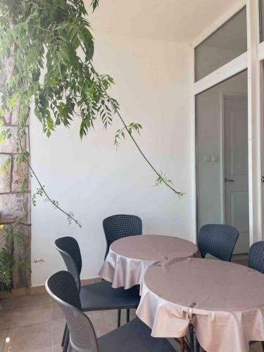 a meeting room with two tables and chairs at Prizba Tomas 1 in Blato
