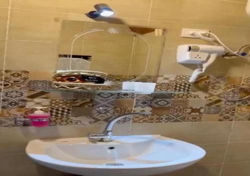 a bathroom with a sink and a mirror at Fenti Nubian Resort in Aswan