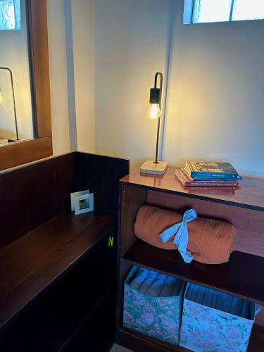 a room with a desk and a shelf with towels at Alpha Apartment View in Serres