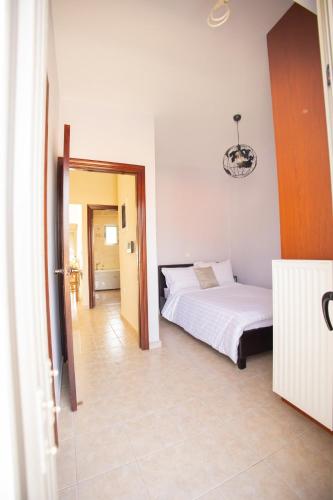 a hotel room with a bed and a hallway at The Calm House in Kineta