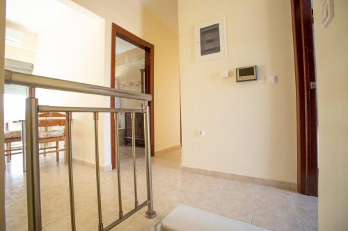 a hallway with a staircase and a dining room at The Calm House in Kineta