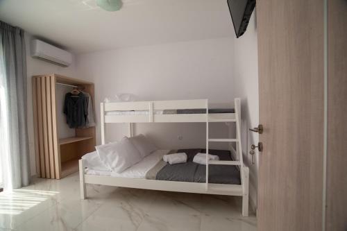 a white bunk bed in a white room at Emma Peris Villa,By Idealstay Experience in Gouves