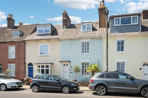 three cars parked in front of a house at Enchanting 3BR House in Lymington with Garden in Lymington