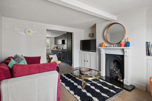a living room with a couch and a mirror at Enchanting 3BR House in Lymington with Garden in Lymington