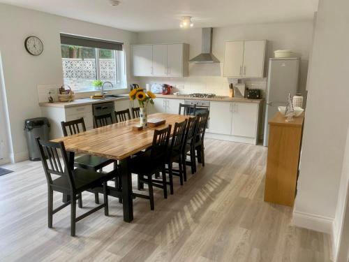 a kitchen with a wooden table and black chairs at Bright, Spacious 5-Bed, 4-Bathroom home on Loch Soy in Portsoy