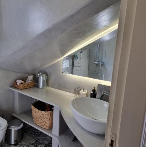 a bathroom with a sink and a mirror at MARINA'S HOUSE - Serenity in Poros