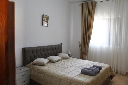 a bedroom with a bed with two towels on it at Hotel VANGJELI Orikum in Orikum