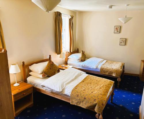 a bedroom with two beds and a window at Thaxted Bed & Breakfast and Accommodation in Thaxted