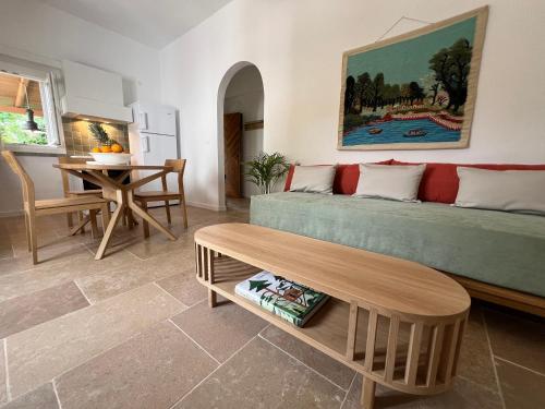 a living room with a couch and a table at Sycamore House in Skiathos Town