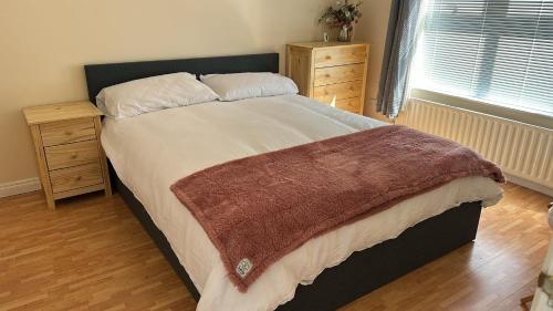 a bedroom with a large bed and two night stands at Cumberland in Ballycastle