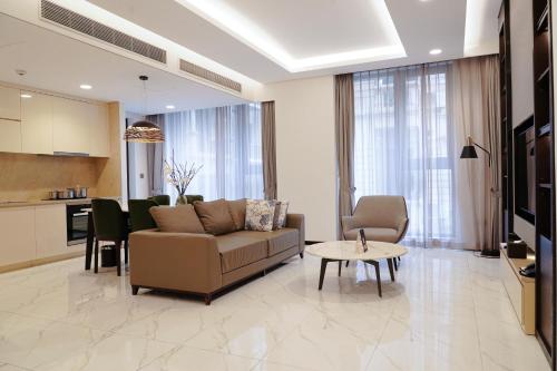 a living room with a couch and a table at The Five Residences Hanoi in Hanoi