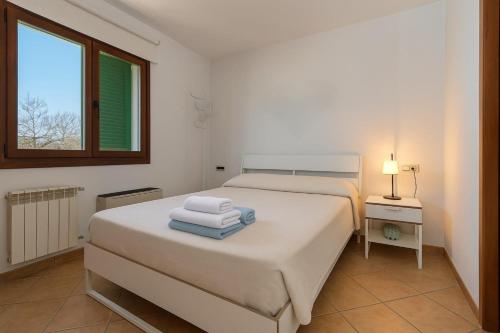 a bedroom with a bed with two towels on it at Townhouse Ses Passadores in Porreres