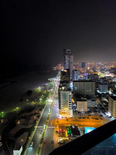 a city lit up at night with buildings and traffic at Sunset Ajman Beach - kids friendly in Ajman 