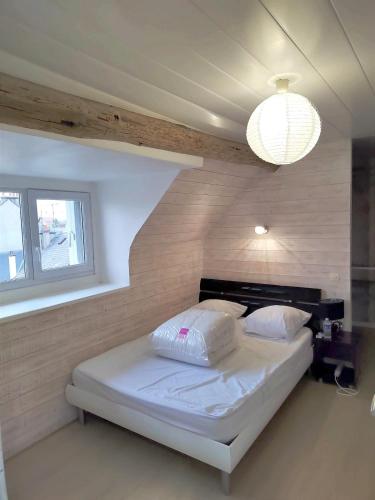 - une chambre avec un lit dans un dortoir doté d'une lampe dans l'établissement Le panoramique centre ville & RER 10 min, à Étampes