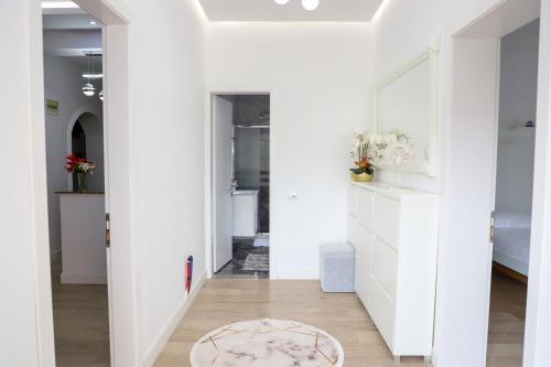 a hallway with white walls and a rug on the floor at Apartment Countryside in Velabishti