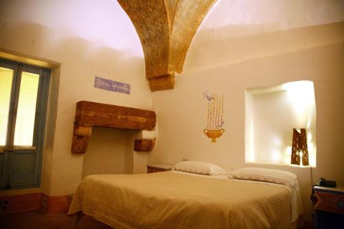 Una cama o camas en una habitación de B&B Palazzo Briganti