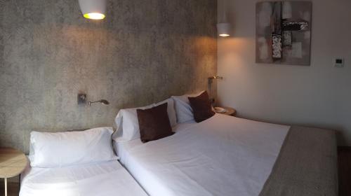 Postel nebo postele na pokoji v ubytování Hotel Lloret Ramblas