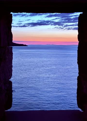 a view of the ocean seen through a window at Bright, Spacious 5-Bed, 4-Bathroom home on Loch Soy in Portsoy